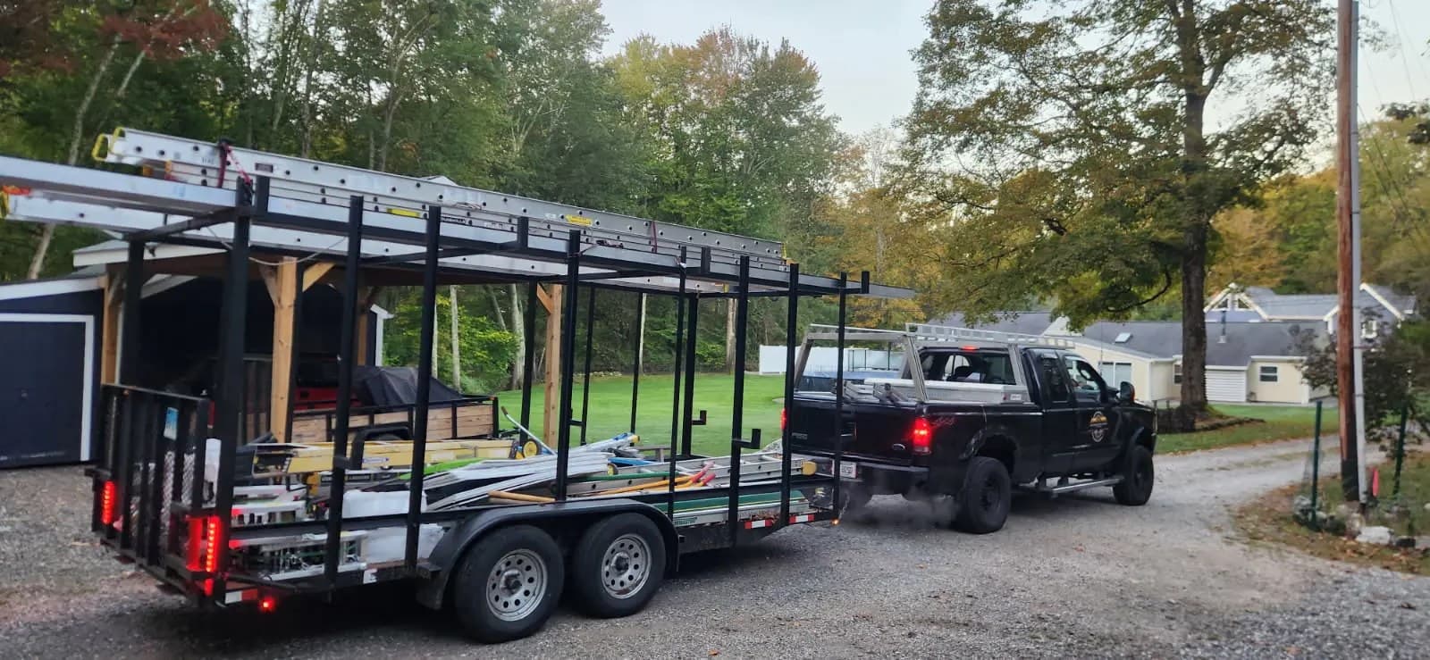 The KMAX Renovations & Repairs work truck and ladder trailer