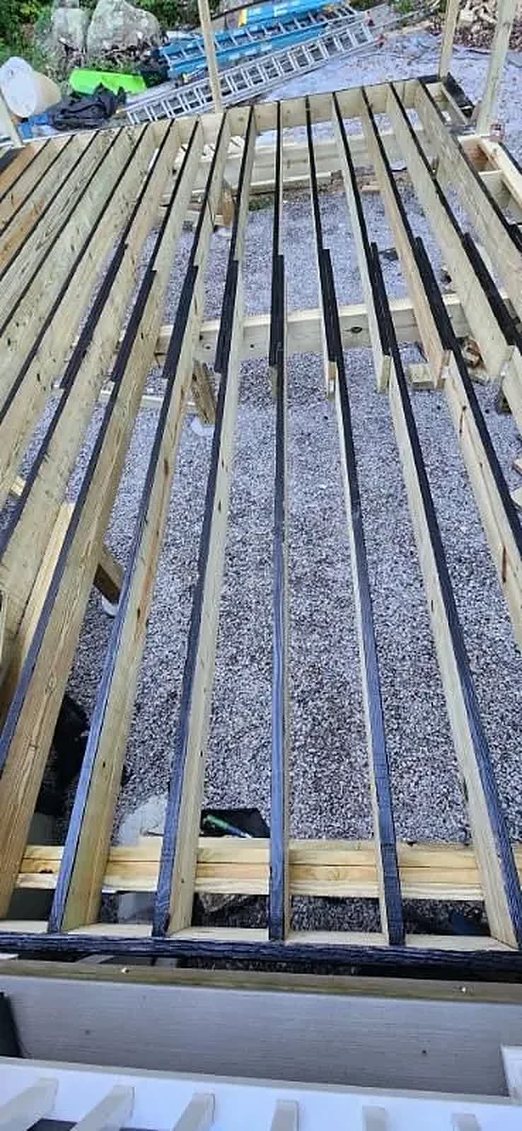 New pressure-treated deck joists set over gravel