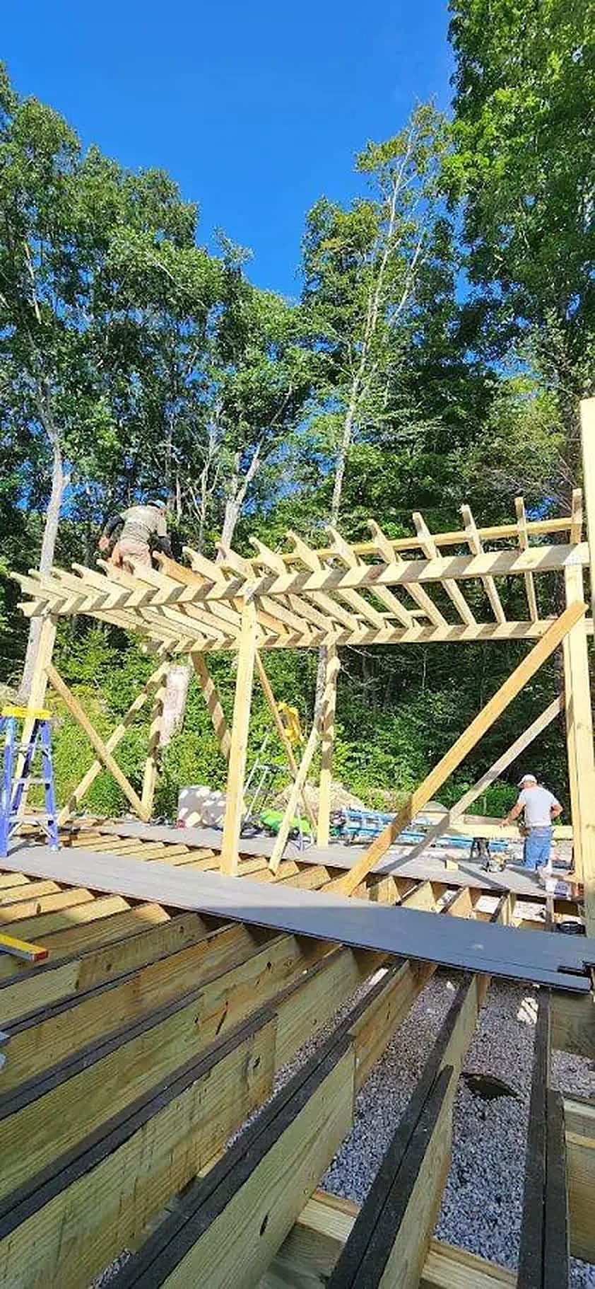 Timber pergola frame going up over a new deck