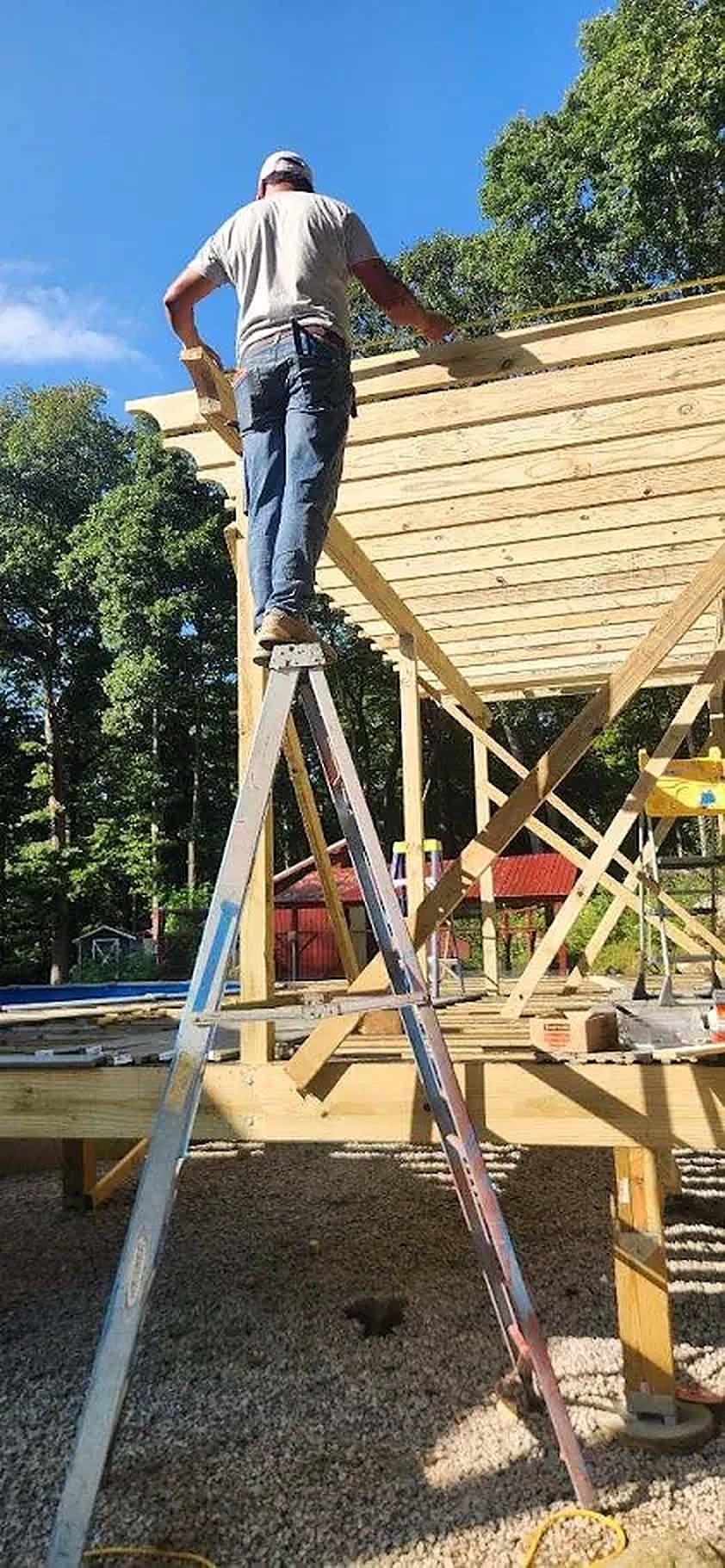 KMAX crew framing a heavy-timber pergola over a new deck